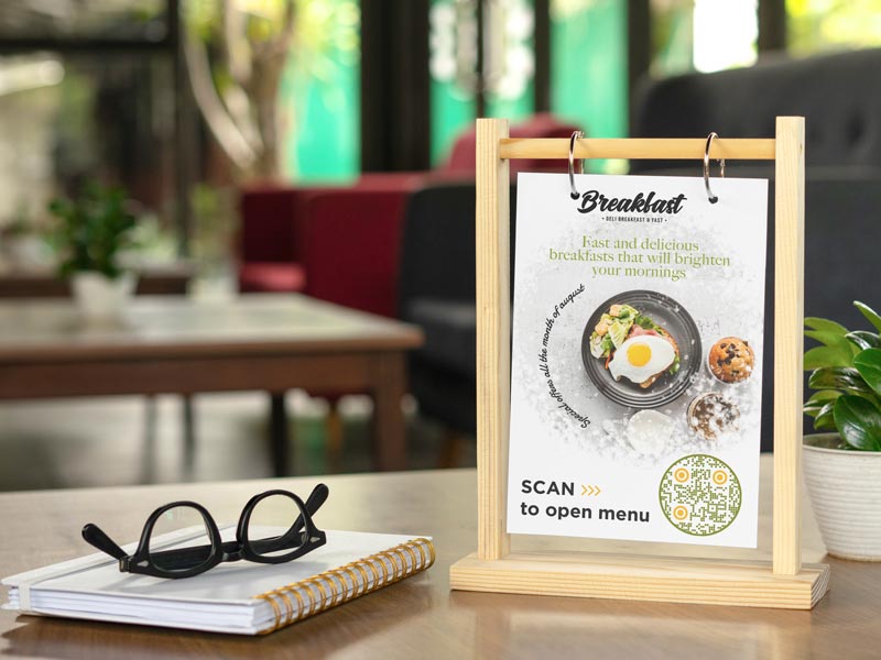 A restaurant table with a few Menu QR codes placed on it