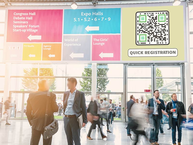 Massiivne reklaambänner konverentsile, mis sisaldab QR-koodi registreerimiseks.